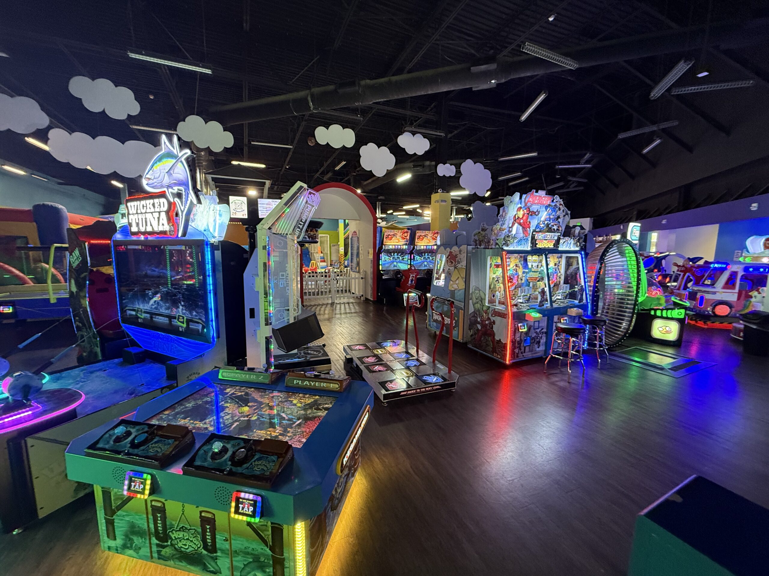 Colorful arcade floor with air hockey and ticket games at The Bounce Place in Lakewood
