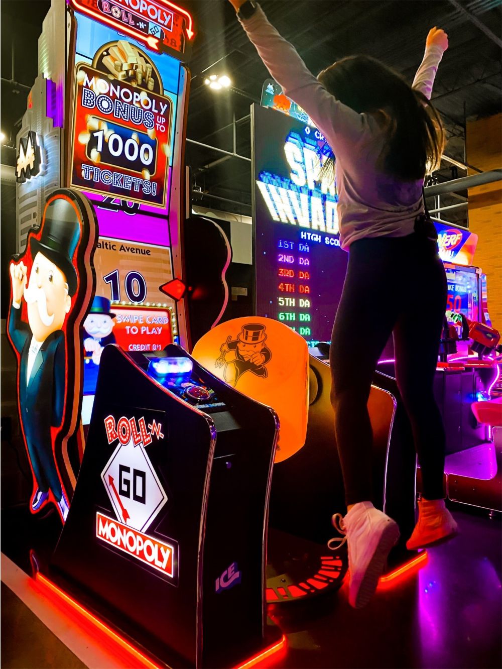 Child celebrating a win on the Monopoly arcade game at The Bounce Place