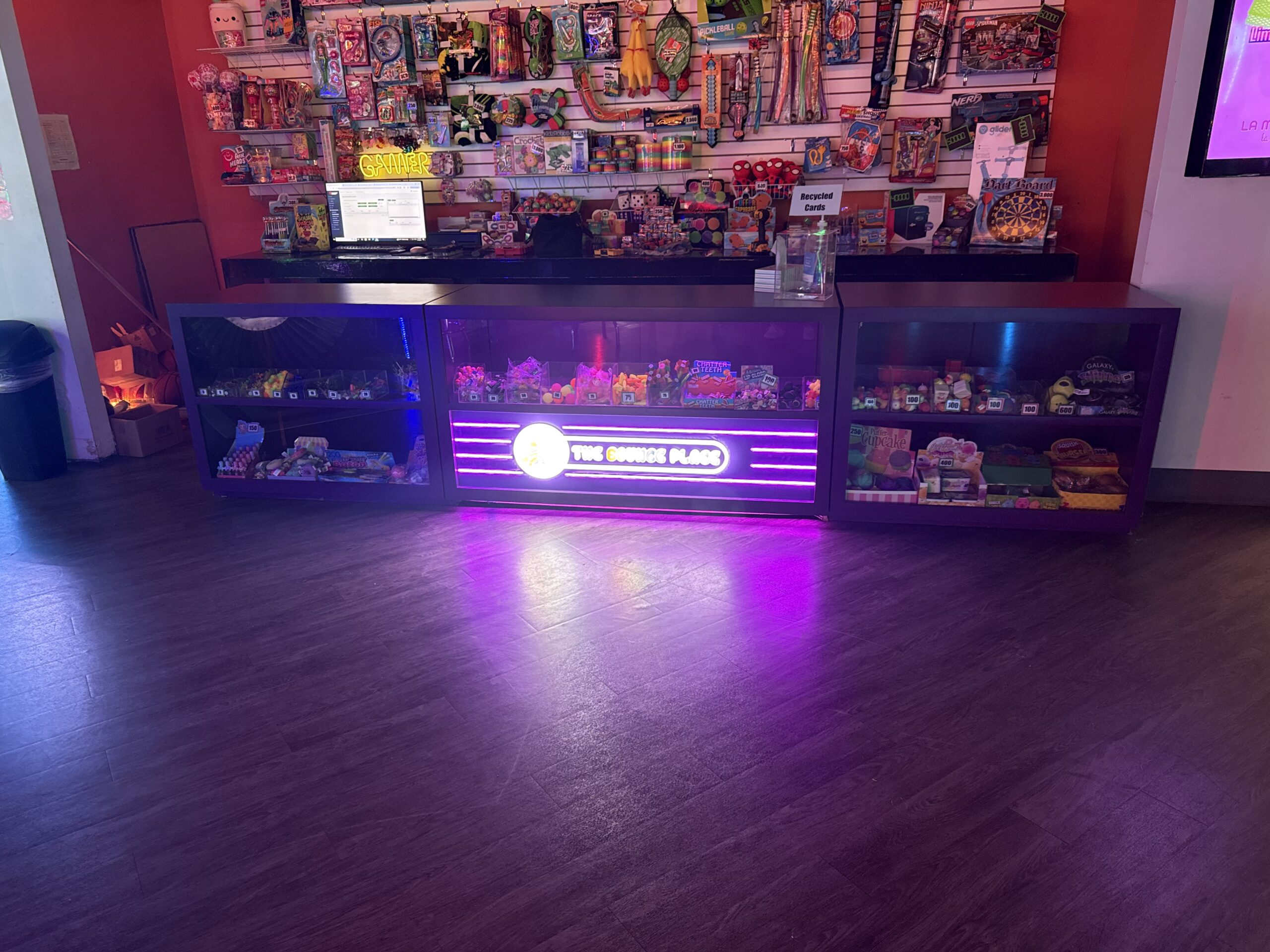 Prize redemption counter filled with colorful rewards at The Bounce Place arcade